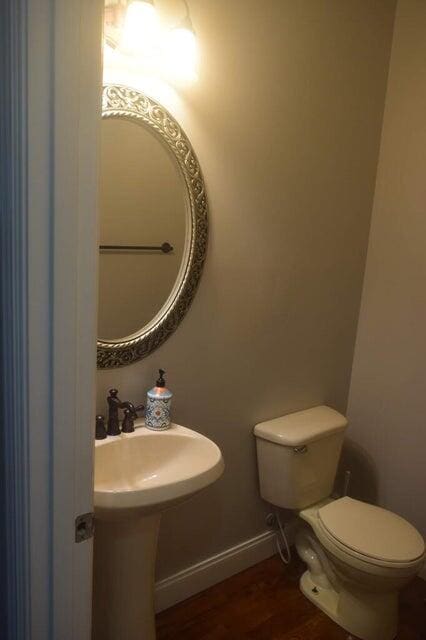 bathroom featuring toilet and hardwood / wood-style flooring