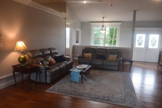 living room with dark wood-type flooring and vaulted ceiling