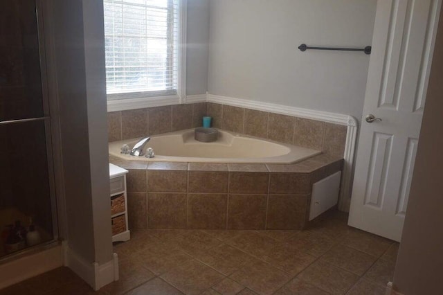 bathroom with tile patterned flooring and shower with separate bathtub