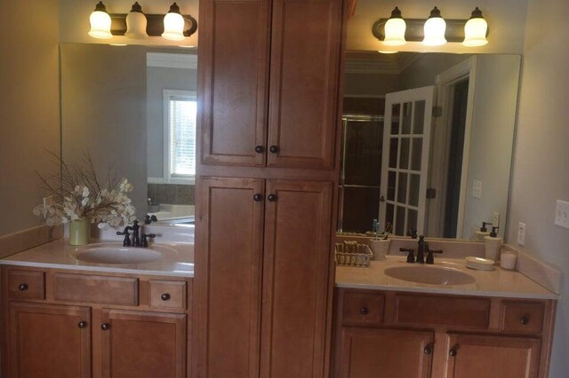 bathroom with plus walk in shower, crown molding, and vanity