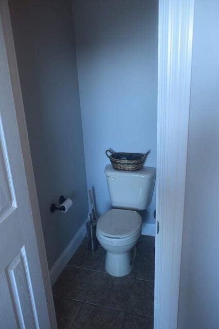 bathroom featuring toilet and tile patterned floors