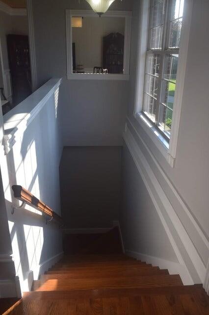 stairway with hardwood / wood-style flooring