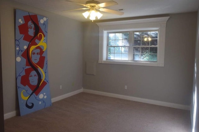 unfurnished room with ceiling fan and carpet