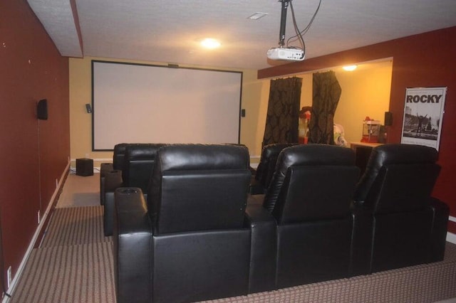 carpeted home theater room featuring a textured ceiling