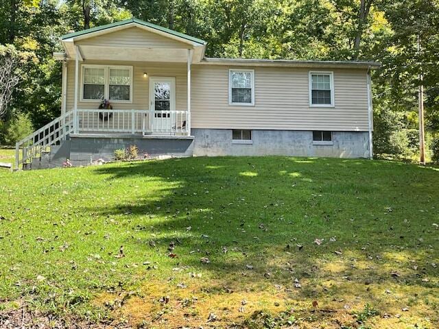 view of front of house featuring a front lawn and covered porch