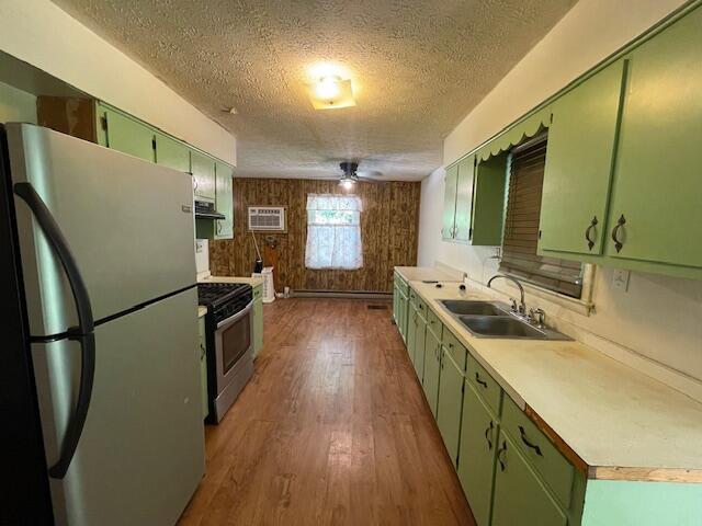 kitchen with stainless steel appliances, dark hardwood / wood-style flooring, a textured ceiling, and sink