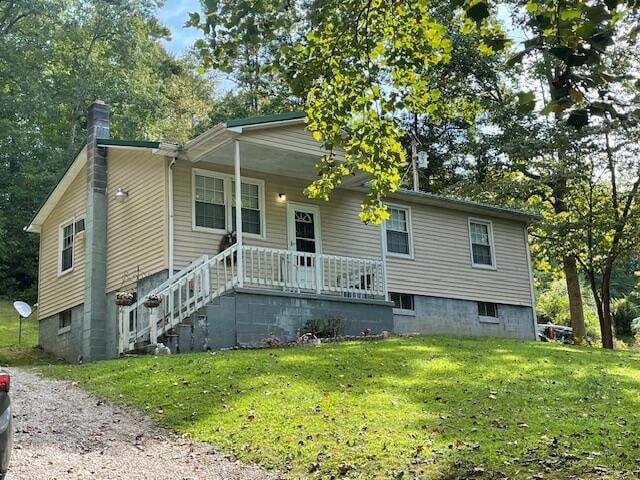 view of front of property with a porch and a front lawn