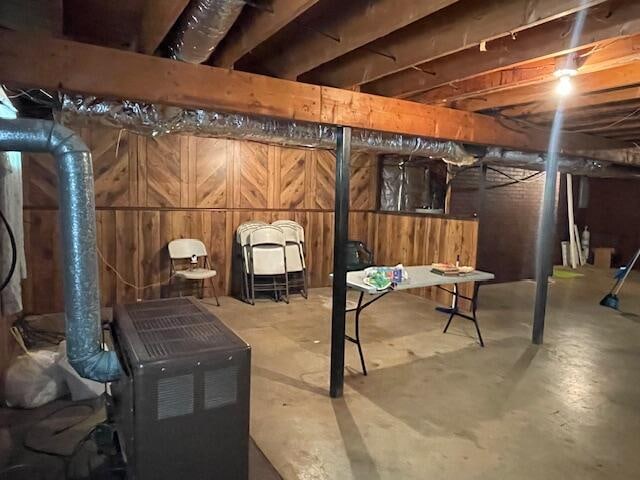 basement featuring wooden walls