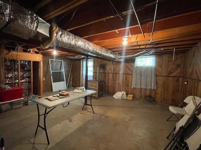 basement featuring wooden walls