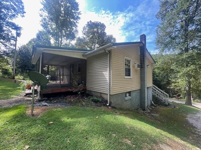 view of side of home featuring a yard