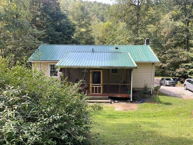 rear view of house featuring a yard