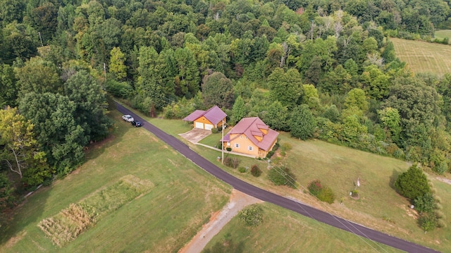 birds eye view of property with a view of trees