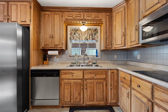 kitchen with light tile patterned floors, stainless steel appliances, tasteful backsplash, and sink