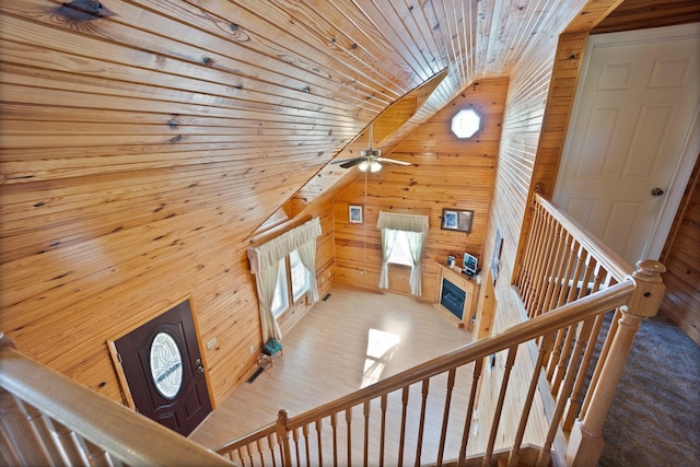 stairs featuring wood walls and wooden ceiling