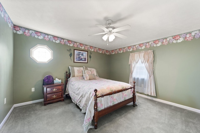 carpeted bedroom featuring multiple windows and ceiling fan