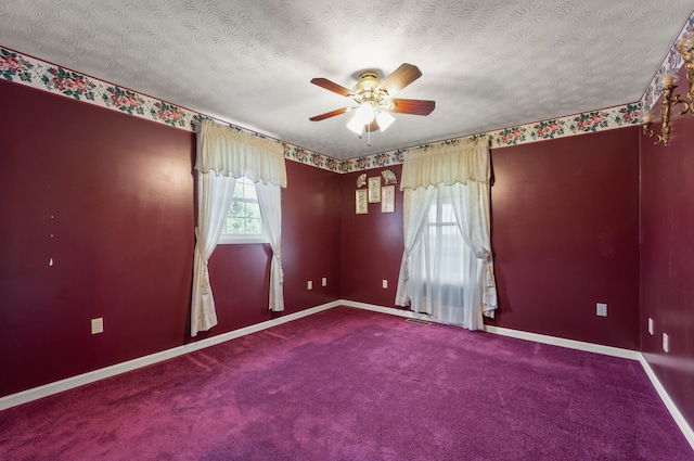 empty room featuring carpet, ceiling fan, and a textured ceiling