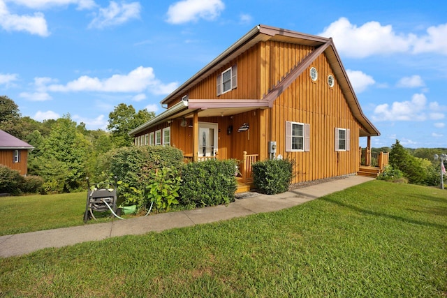 view of side of home with a lawn