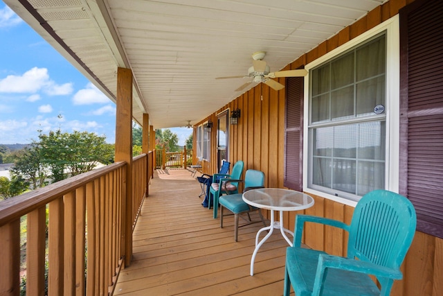 wooden deck featuring a porch and ceiling fan