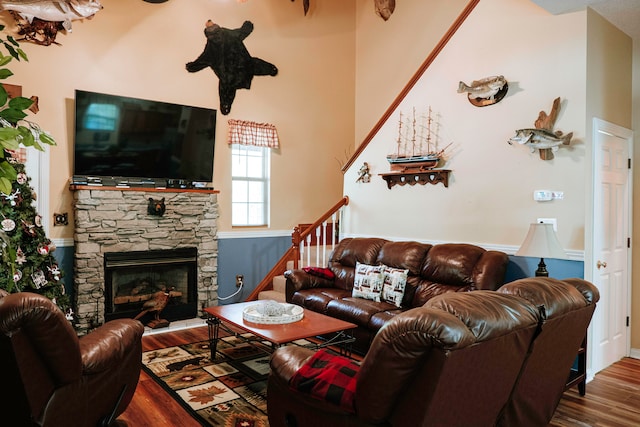 living room with a fireplace and wood-type flooring