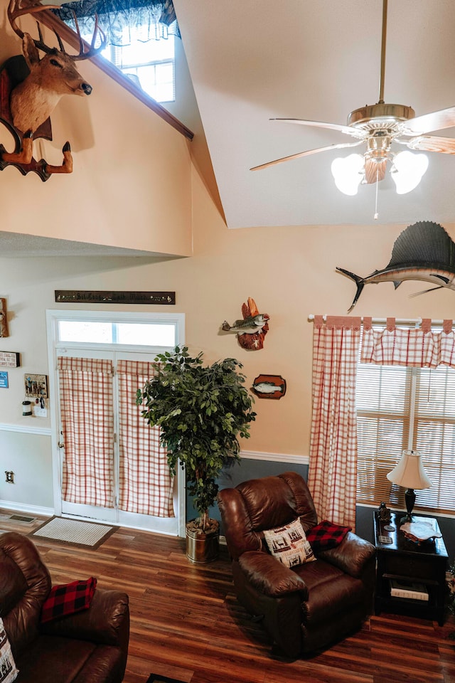 living room with high vaulted ceiling, ceiling fan, and wood-type flooring