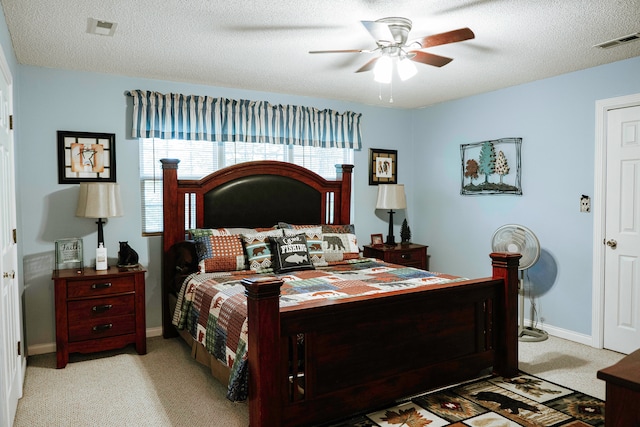 carpeted bedroom featuring a textured ceiling and ceiling fan