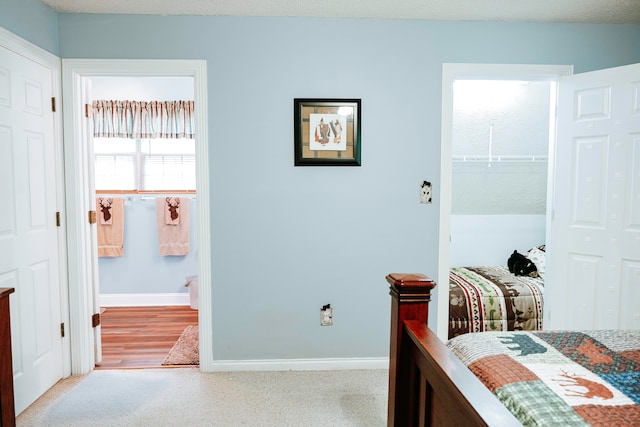 bedroom with light wood-type flooring and a textured ceiling