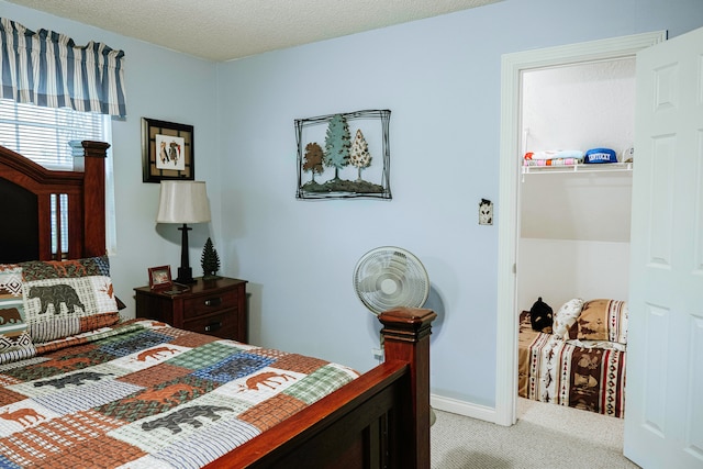 bedroom with carpet flooring and a textured ceiling