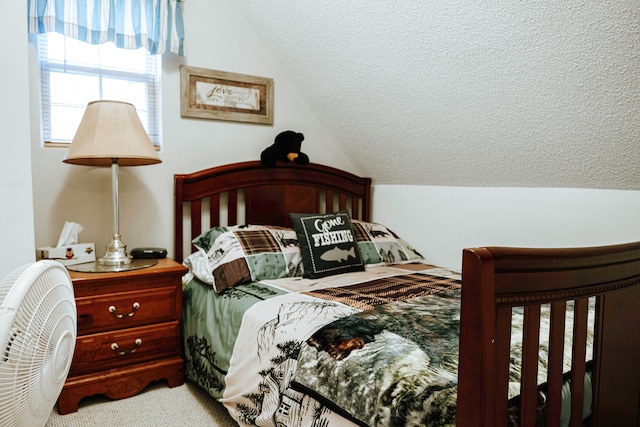 bedroom featuring a textured ceiling, light colored carpet, and vaulted ceiling