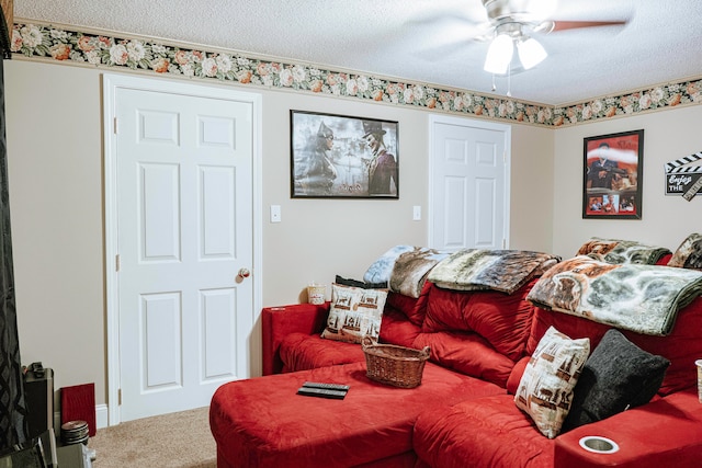 carpeted living room with a textured ceiling and ceiling fan