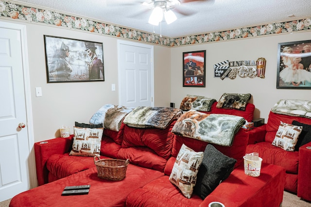 carpeted living room with ceiling fan and a textured ceiling