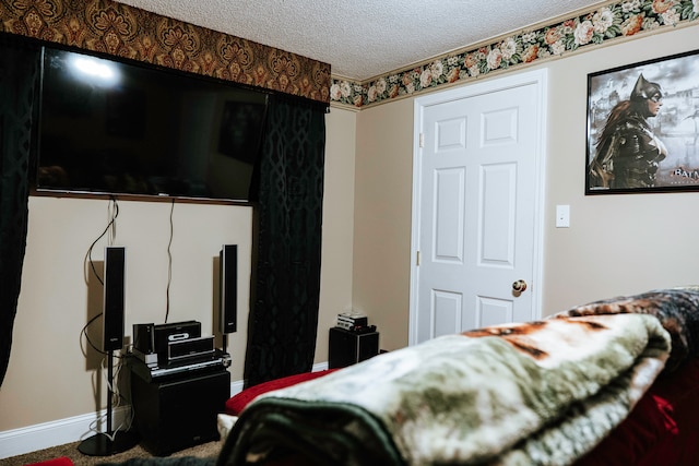 bedroom featuring carpet floors and a textured ceiling