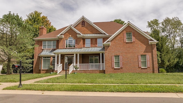 view of front of home with a front yard and a porch