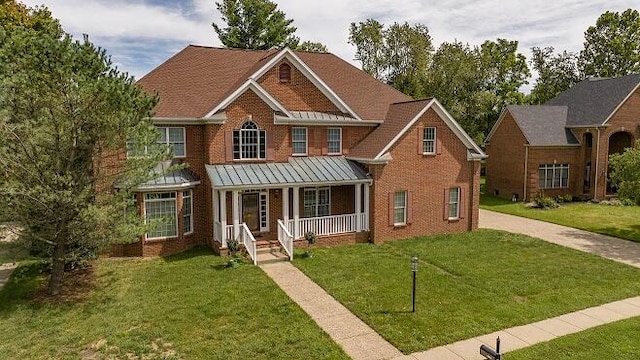 view of front of property featuring a porch and a front lawn