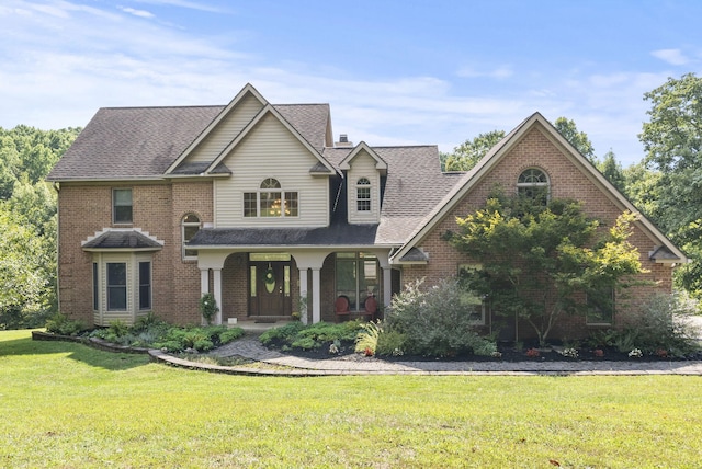 front facade with a front lawn and a porch