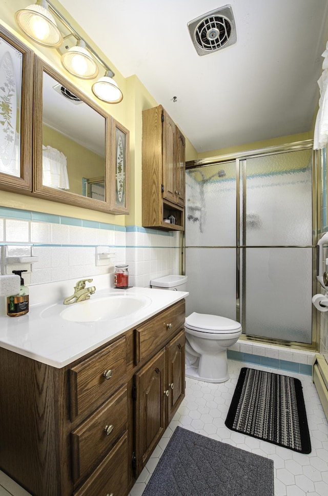 full bathroom with vanity, visible vents, a shower stall, tile patterned floors, and toilet