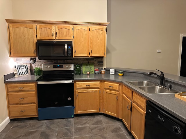 kitchen featuring black appliances, backsplash, sink, and dark tile patterned floors