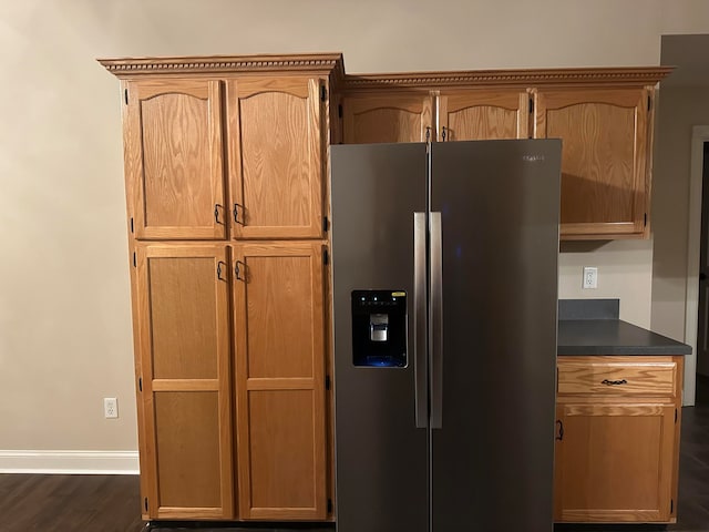 kitchen with dark hardwood / wood-style floors and stainless steel fridge with ice dispenser