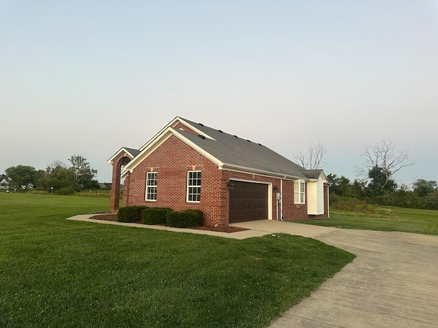 view of side of home featuring a lawn and a garage