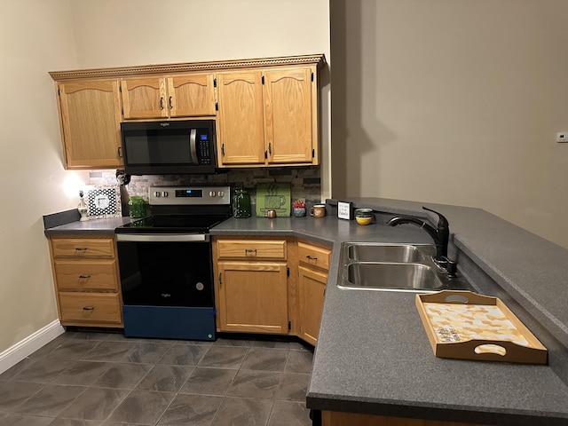 kitchen featuring decorative backsplash, dark countertops, a sink, baseboards, and black appliances