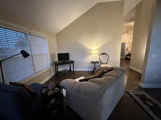 living area featuring baseboards, lofted ceiling, and wood finished floors