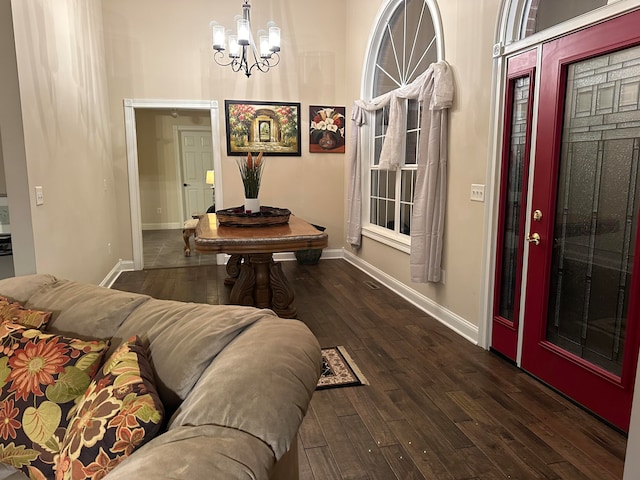 dining area featuring an inviting chandelier and dark wood-type flooring