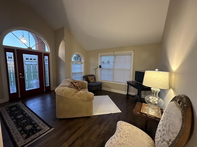 living room featuring baseboards, high vaulted ceiling, and wood finished floors