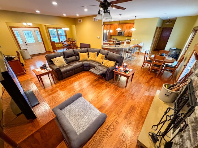 living room with hardwood / wood-style floors and ceiling fan