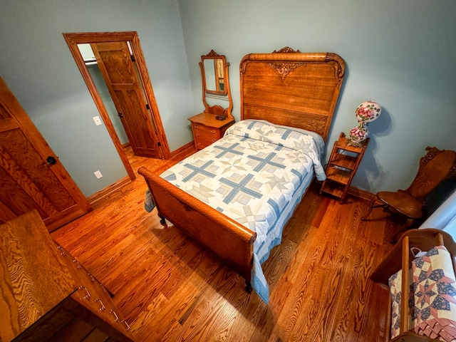 bedroom with hardwood / wood-style floors