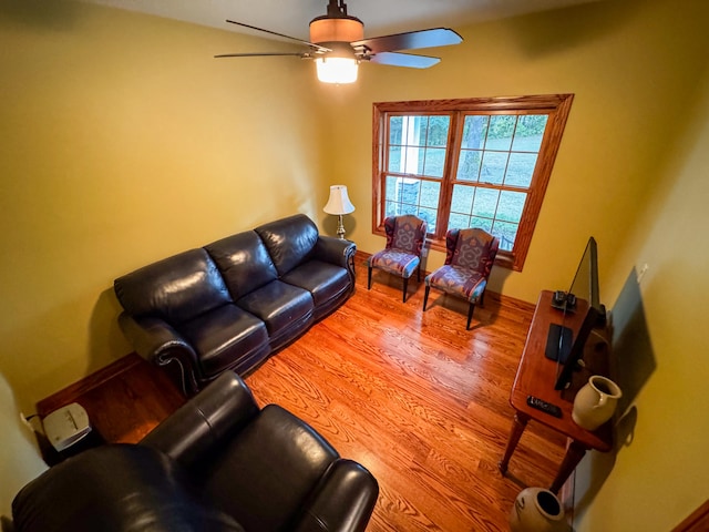 living room with wood-type flooring and ceiling fan