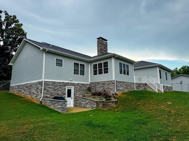 rear view of property with a yard and a patio