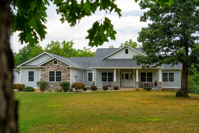 view of front of home with covered porch and a front yard