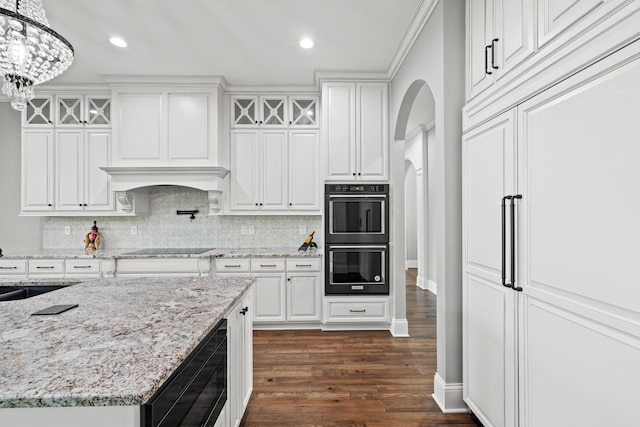 kitchen featuring black appliances, white cabinetry, an inviting chandelier, and dark hardwood / wood-style floors