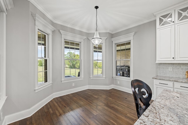 unfurnished office with crown molding, a healthy amount of sunlight, a chandelier, and dark hardwood / wood-style flooring