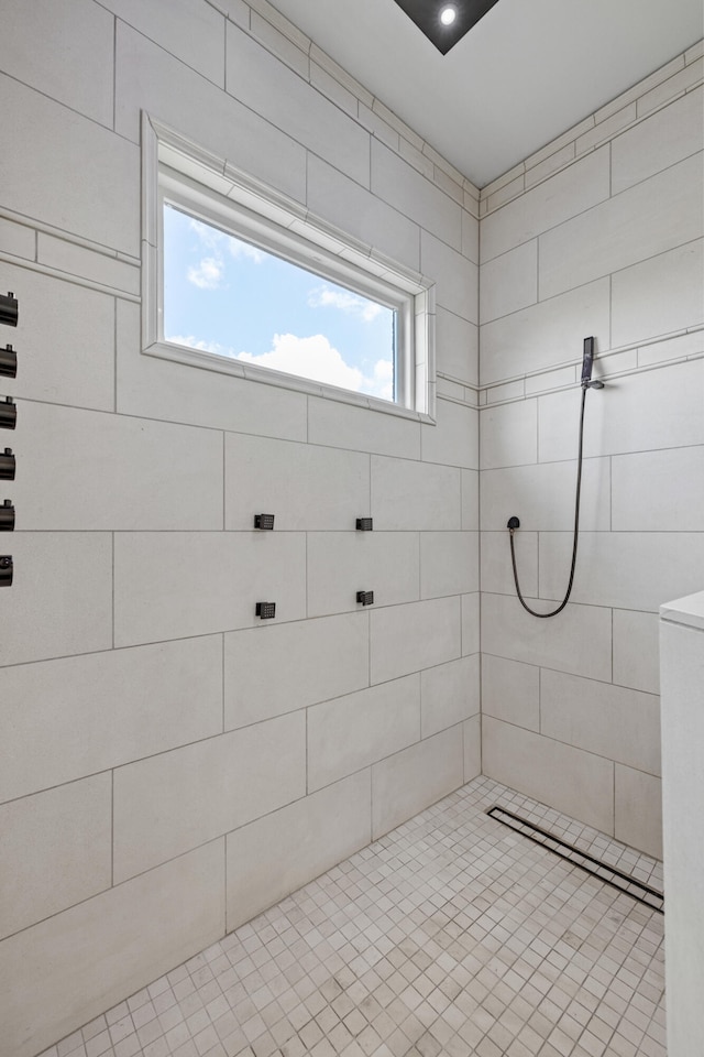 bathroom featuring tiled shower and a healthy amount of sunlight